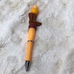Handcrafted  orange pen with cowboy boot. Orange/brown. bpa free silicone.